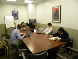 STUDENTS LEARN IN CRAMPED AND UNEQUIPPED ENVIRONMENT: From left to right: Colson Andrews '17, Dr. Jie Cai, Gregory Smith '17, Darren Wood '16 Photo Courtesy of Ob Peters '16