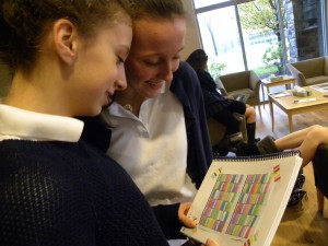 CHANGE IS  IN THE AIR: Freshmen Lauren Weil '19 (left) and Allison Lee ' 19 (right) look at a draft of the new schedule. Photo Courtesy  of Minjee Cho '19