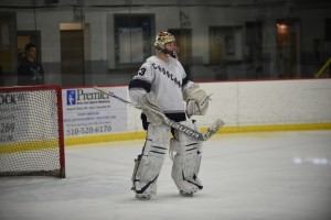 SURVEYING THE LAND: Ben Glidden '16 looks out across the ice and organizes the Episcopal defense, preparing himself to save the incoming shot. Photo courtesy of John Halcovich '18