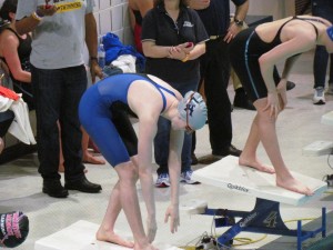 DIVING FOR GOLD: Emma Seiberlich '17 lines up with other swimmers at the yearly Easterns competition. Photo Permission of Jill Maher