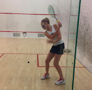 SQUASHING THE OPPONENT: Caroline Burt ‘20, who is also a member of the varsity tennis and lacrosse teams, prepares to hit the ball.  Photo Courtesy of Caroline Burt ‘20