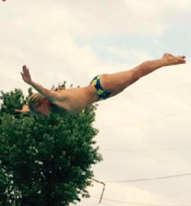 DIVING INTO THE WINTER SEASON: Puskovitch demonstrates his impressive diving ability and talent at an outdoor meet. Photo Courtesy of Jessica Brady ‘18