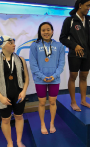 SWIMMER WITH A SMILE: Chelsey poses alongside her competitors after grabbing 3rd place in the 50 free. Photo courtesy of @EASwimDive